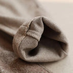 Close-up of beige fabric with a focus on texture and color.