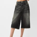 Black denim shorts on a white background