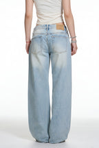 Light blue jeans worn by a person on a white background