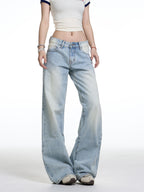 Person wearing light blue flared jeans on a white background