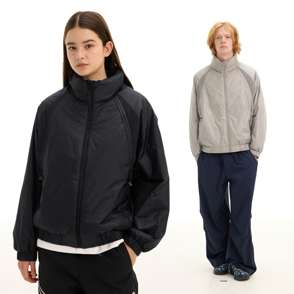 Two people wearing different jackets and pants on a white background
