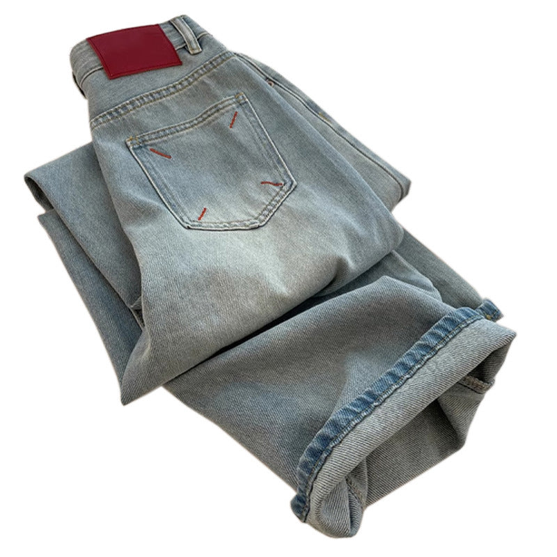 Folded pair of light blue jeans on a white background