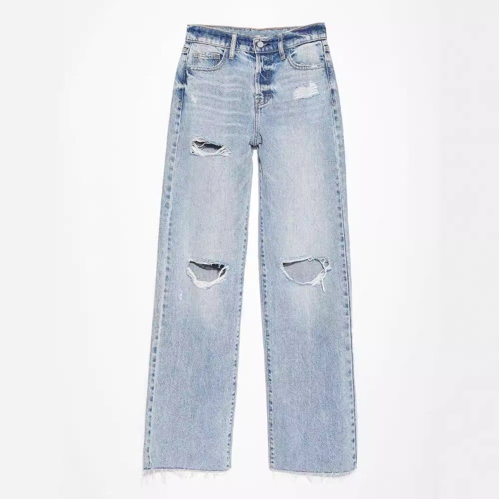 Light blue jeans with distressed details on a white background