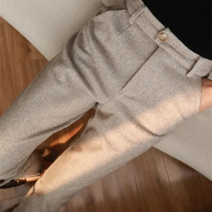 Gray pants with a button on a wooden floor