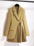 Beige coat with a pleated skirt on a hanger against a white background