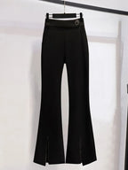 Black flared pants on a hanger against a white background