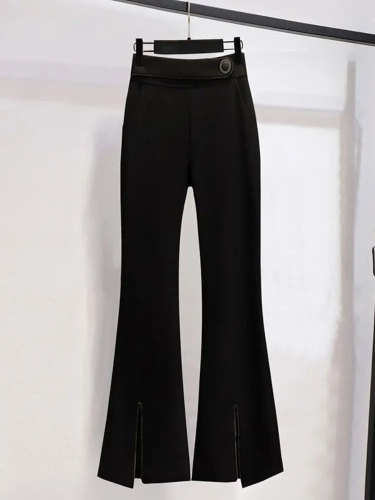 Black flared pants on a hanger against a white background