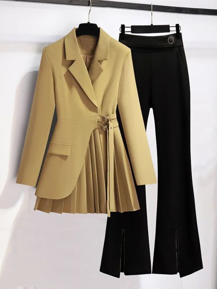 Beige blazer and black pants on hangers against a white background