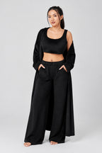 Woman wearing a black outfit with a plain background