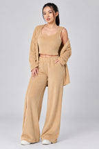 Woman wearing a beige outfit on a plain background
