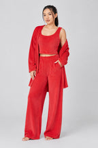 Woman wearing a red outfit on a plain background