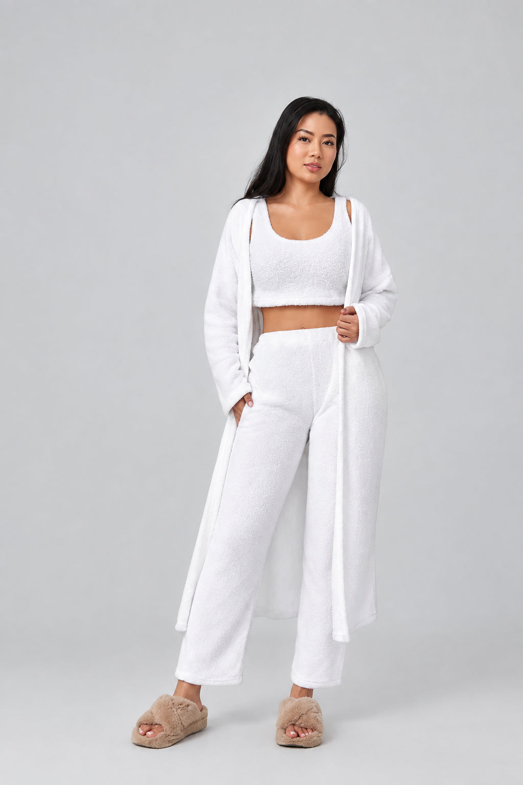Woman wearing a white outfit on a plain background