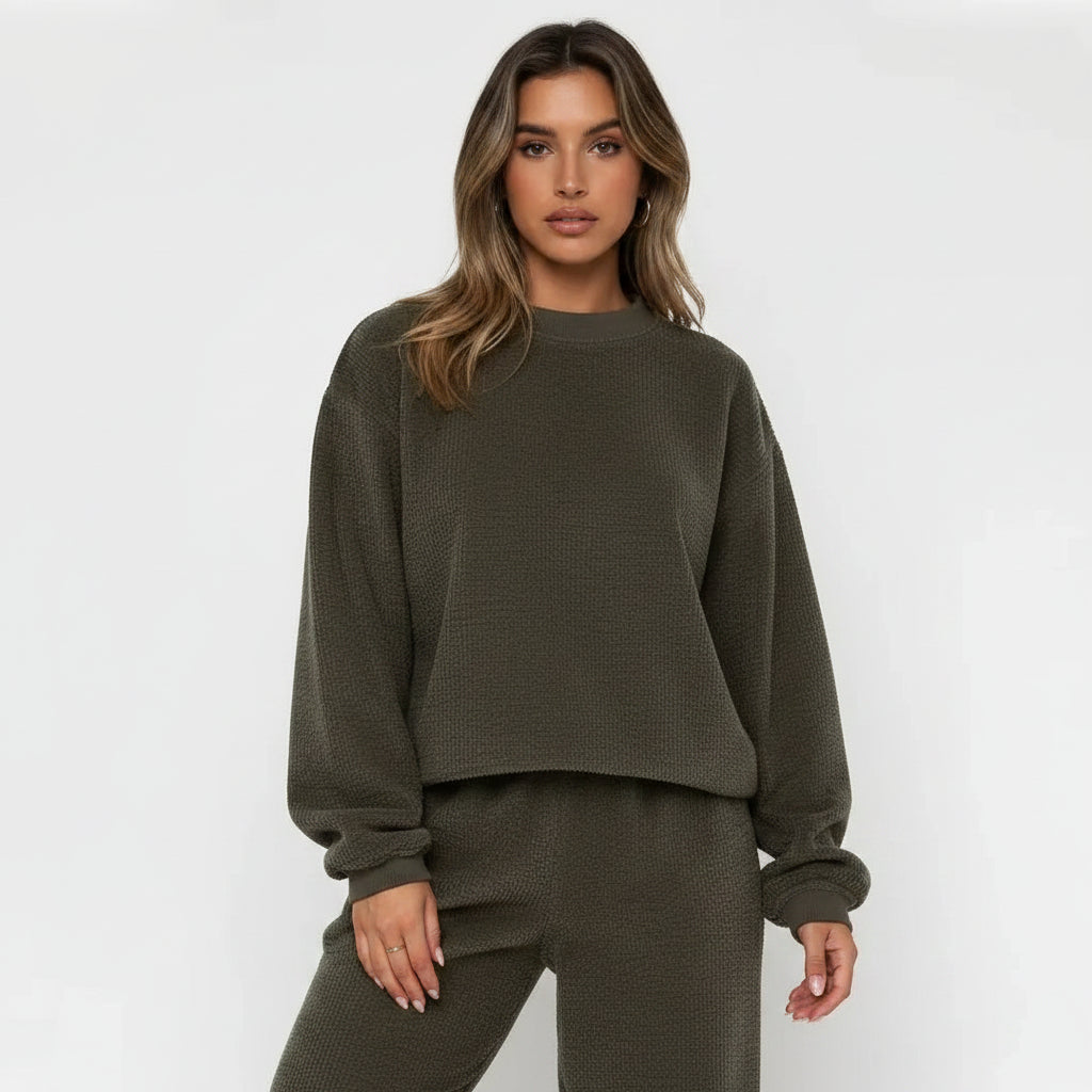 Woman wearing a green tracksuit against a white background