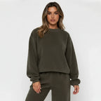 Woman wearing a green tracksuit against a white background