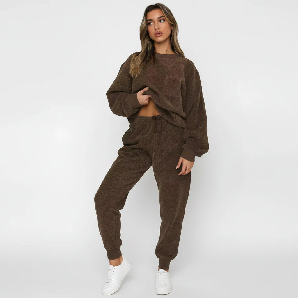 Woman wearing a brown knit outfit on a white background