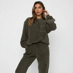 Woman wearing a green lounge set against a white background