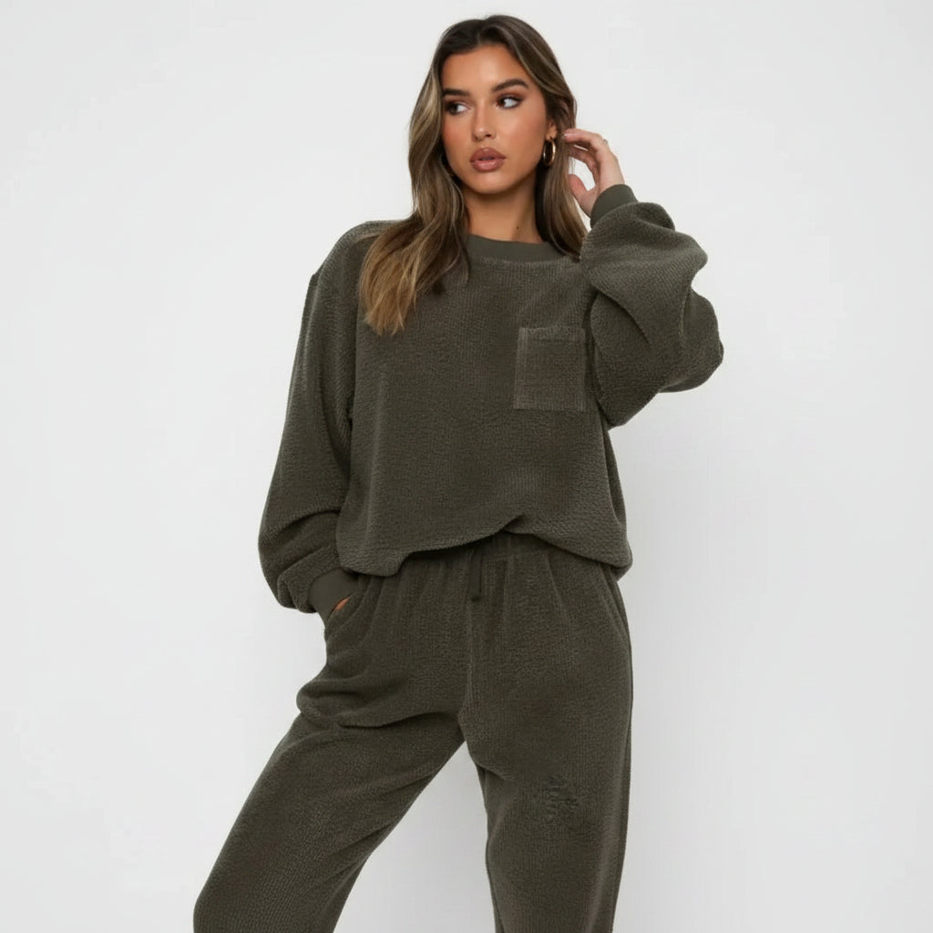 Woman wearing a green lounge set against a white background