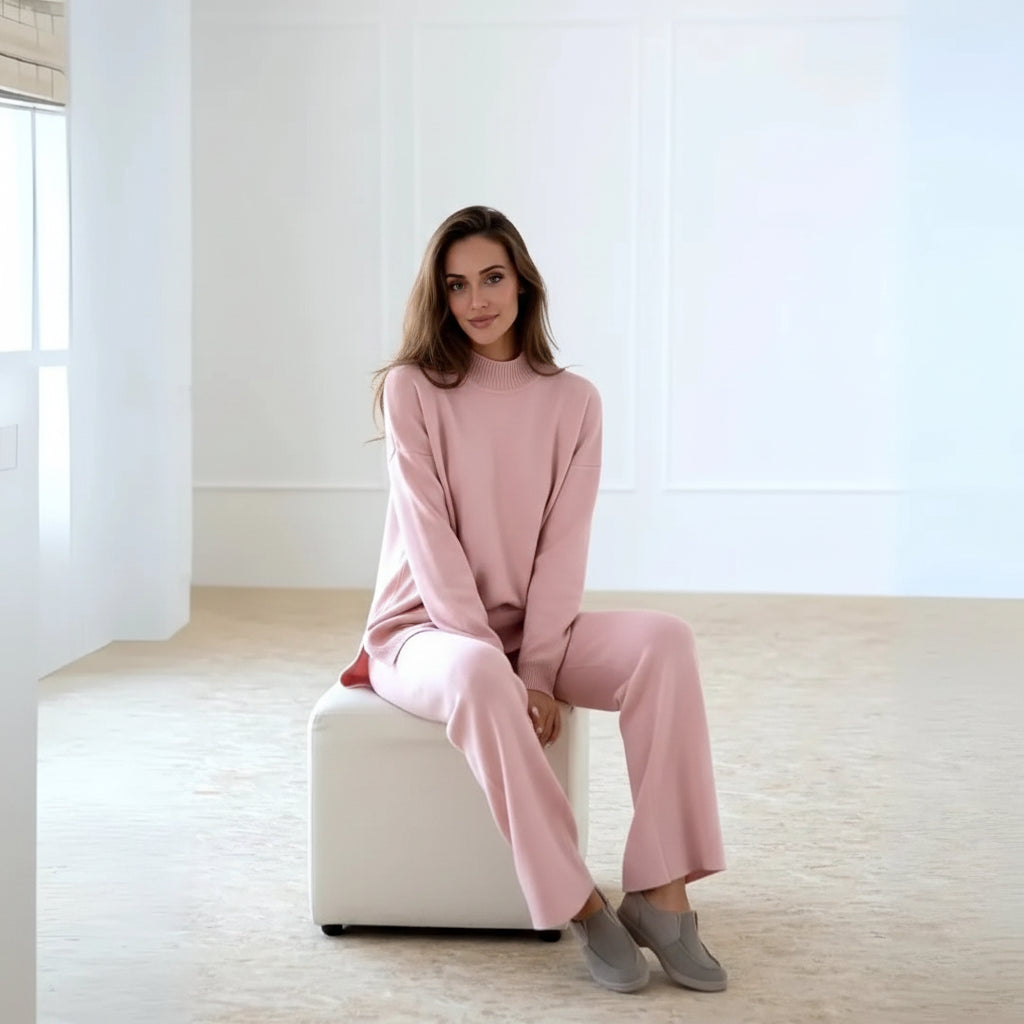 Woman wearing a pink outfit in a minimalistic room