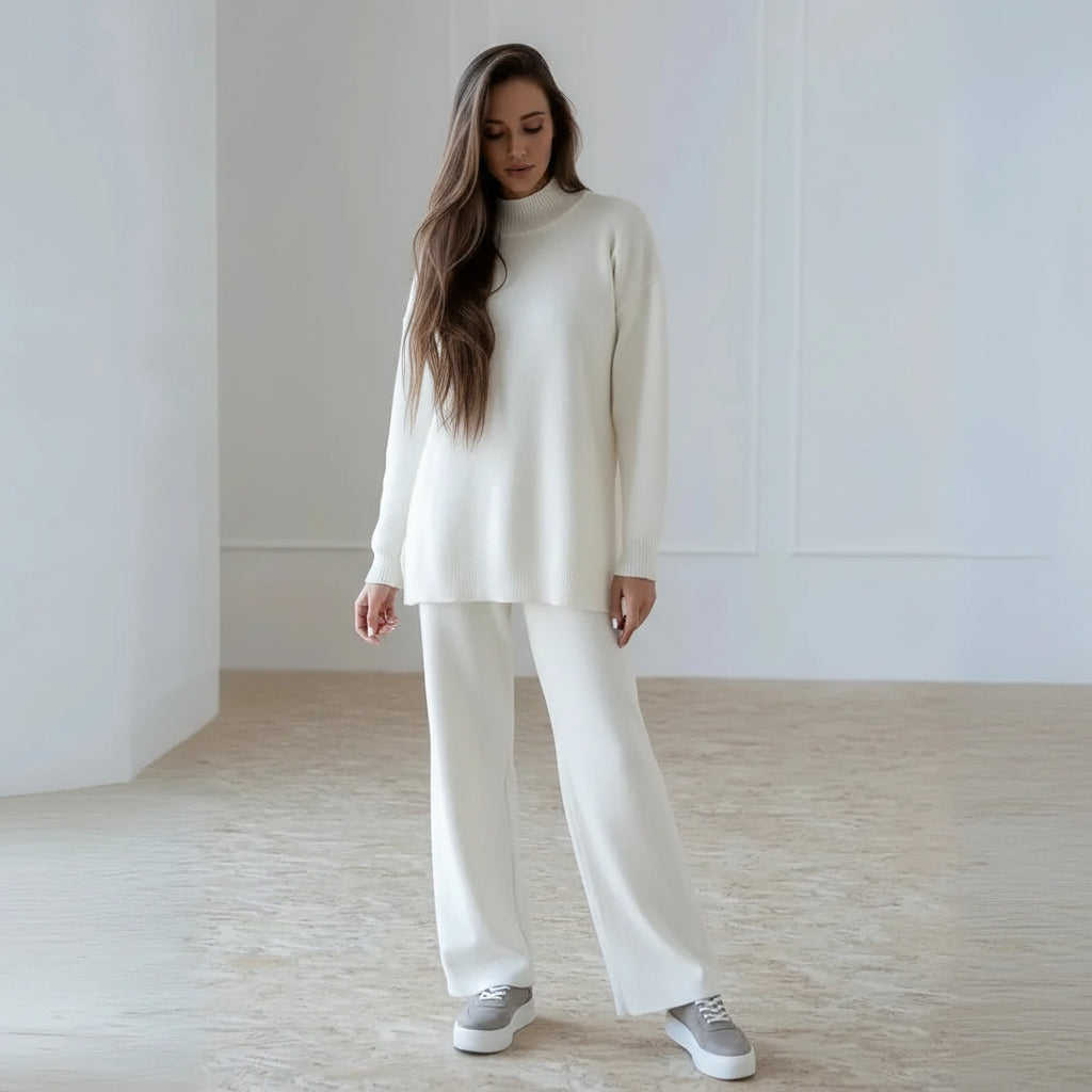 Woman wearing a white outfit in a minimalistic room