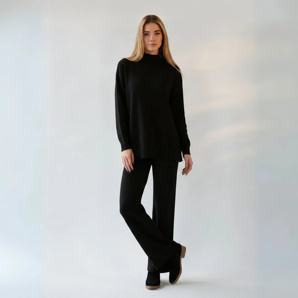 Woman wearing a black outfit against a plain background
