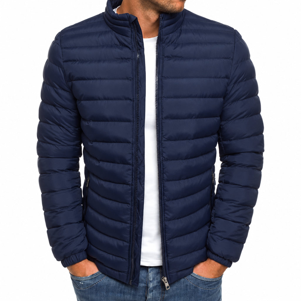 Navy blue puffer jacket worn by a person on a white background