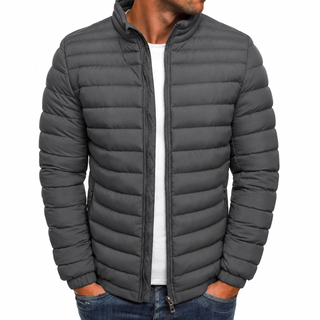 Gray puffer jacket worn by a person on a white background