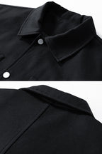 Close-up of a black coat collar with buttons on a white background