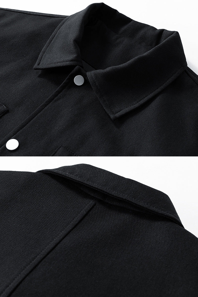 Close-up of a black coat collar with buttons on a white background
