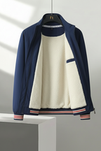 Navy blue jacket with white fleece lining on a gray background