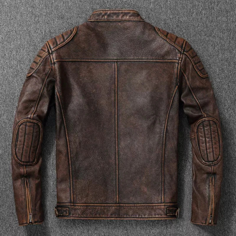 A dark brown distressed leather motorcycle jacket shown from the back, laid flat on a textured gray background.