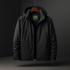 A black hooded jacket hanging on a wooden hanger against a dark studio background. The jacket has a full front zipper, a high collar, and a small green mountain logo patch visible inside the neck area.