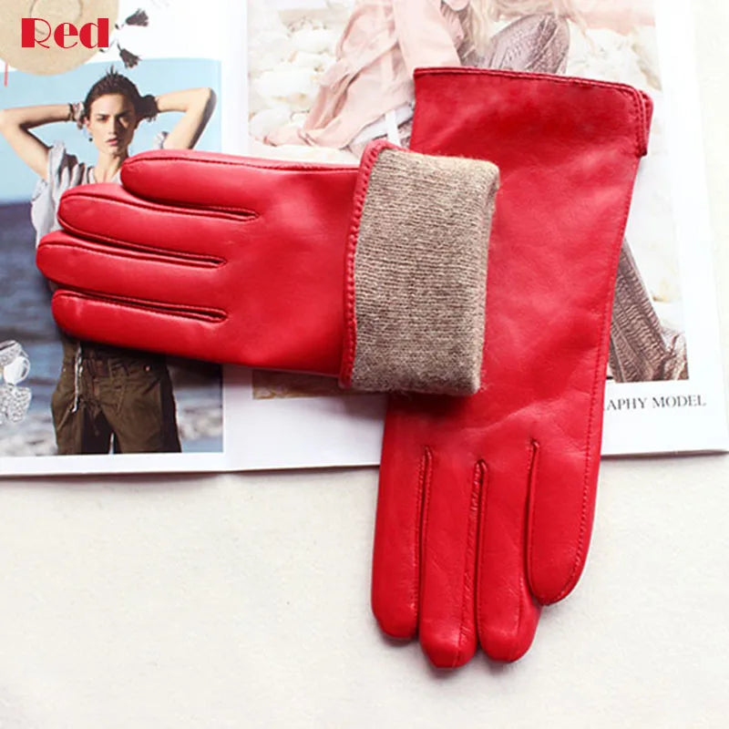 Red leather gloves with a brown cuff on a magazine background