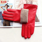 Red leather gloves with a brown cuff on a magazine background