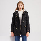 Woman wearing a black coat with gold buttons on a white background