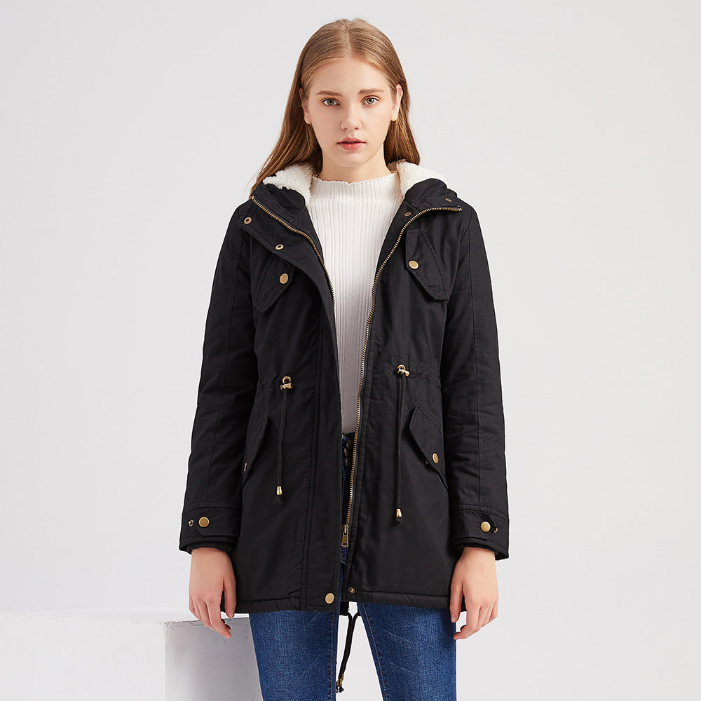 Woman wearing a black coat with gold buttons on a white background