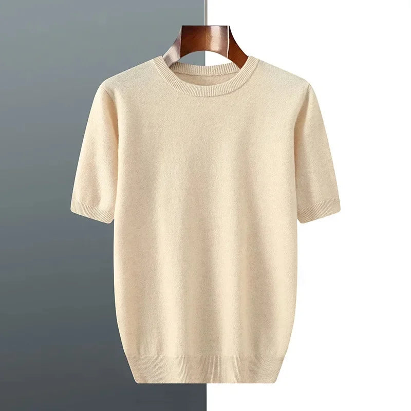 Beige sweater on a hanger against a gray and white background
