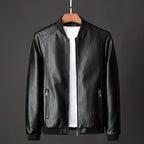 Black leather jacket on a hanger against a gray background