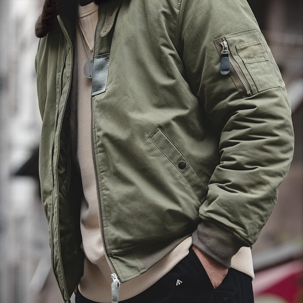 Green jacket worn by a person with a blurred background