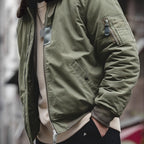Green jacket worn by a person with a blurred background