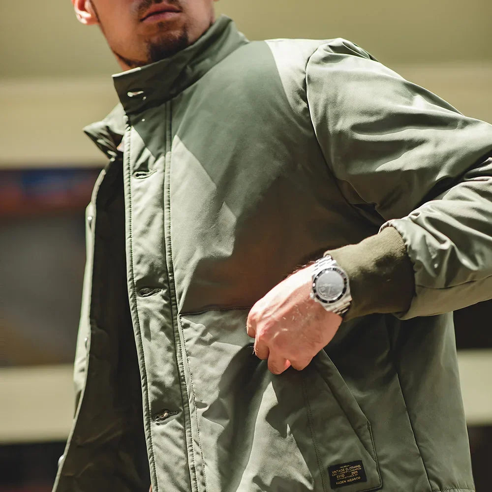 Person wearing a green jacket with a blurred background