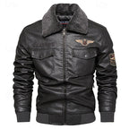Black faux leather bomber jacket with a dark gray sherpa collar, zippered front, flap chest pockets, and embroidered patches on the chest and sleeve, shown on a plain white background.