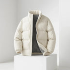 Beige puffer jacket on a white pedestal against a light gray background