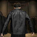 Person wearing a black leather jacket in a clothing store setting