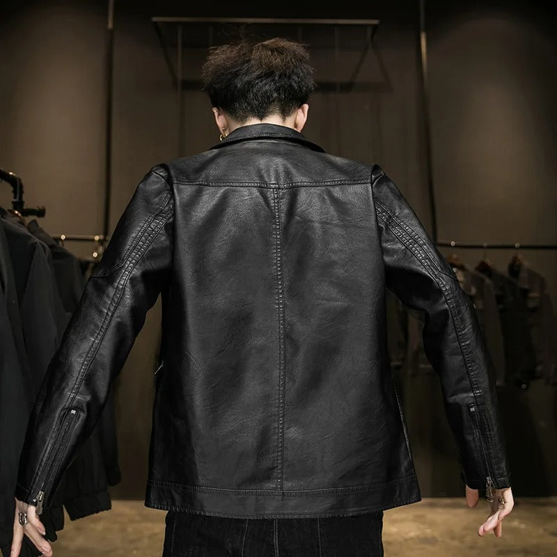 Person wearing a black leather jacket in a clothing store setting