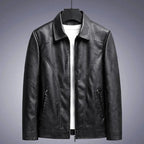 Black leather jacket on a gray background