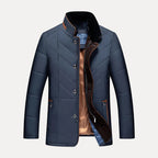 Blue quilted jacket with plaid lining on a light gray background