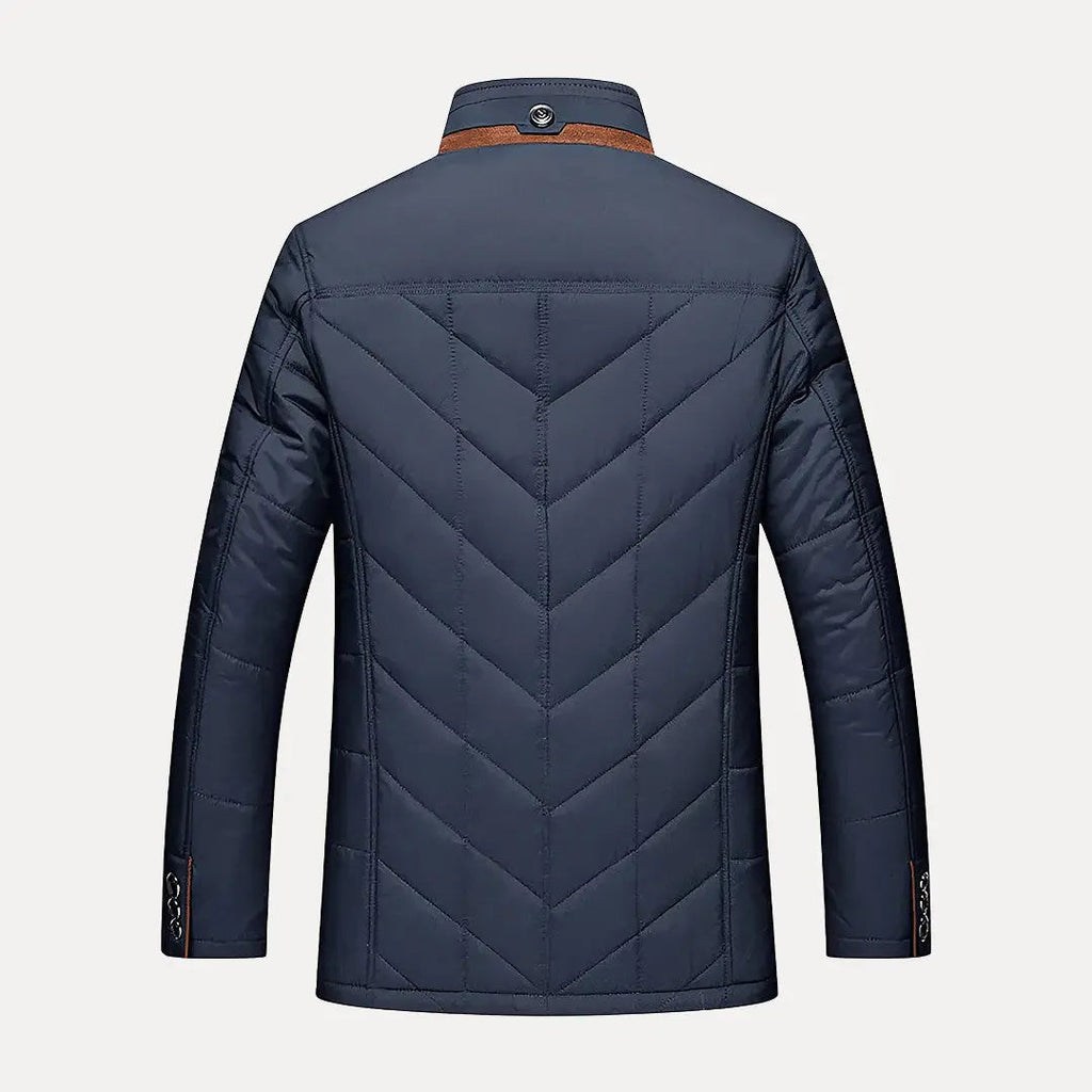Navy blue quilted jacket on a light gray background