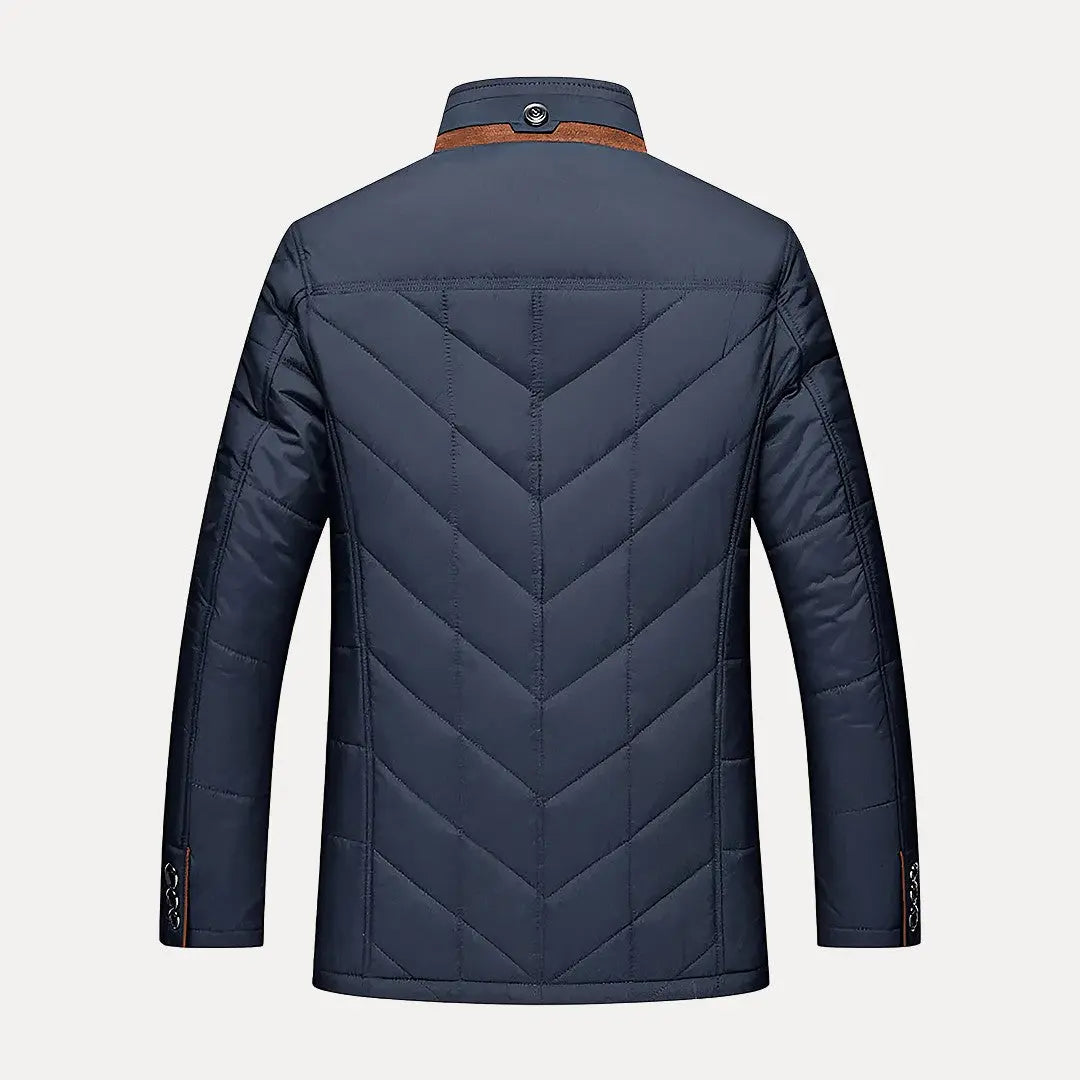 Navy blue quilted jacket on a light gray background