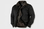 A black jacket with a dark brown sherpa lining, shown open against a light gray background.