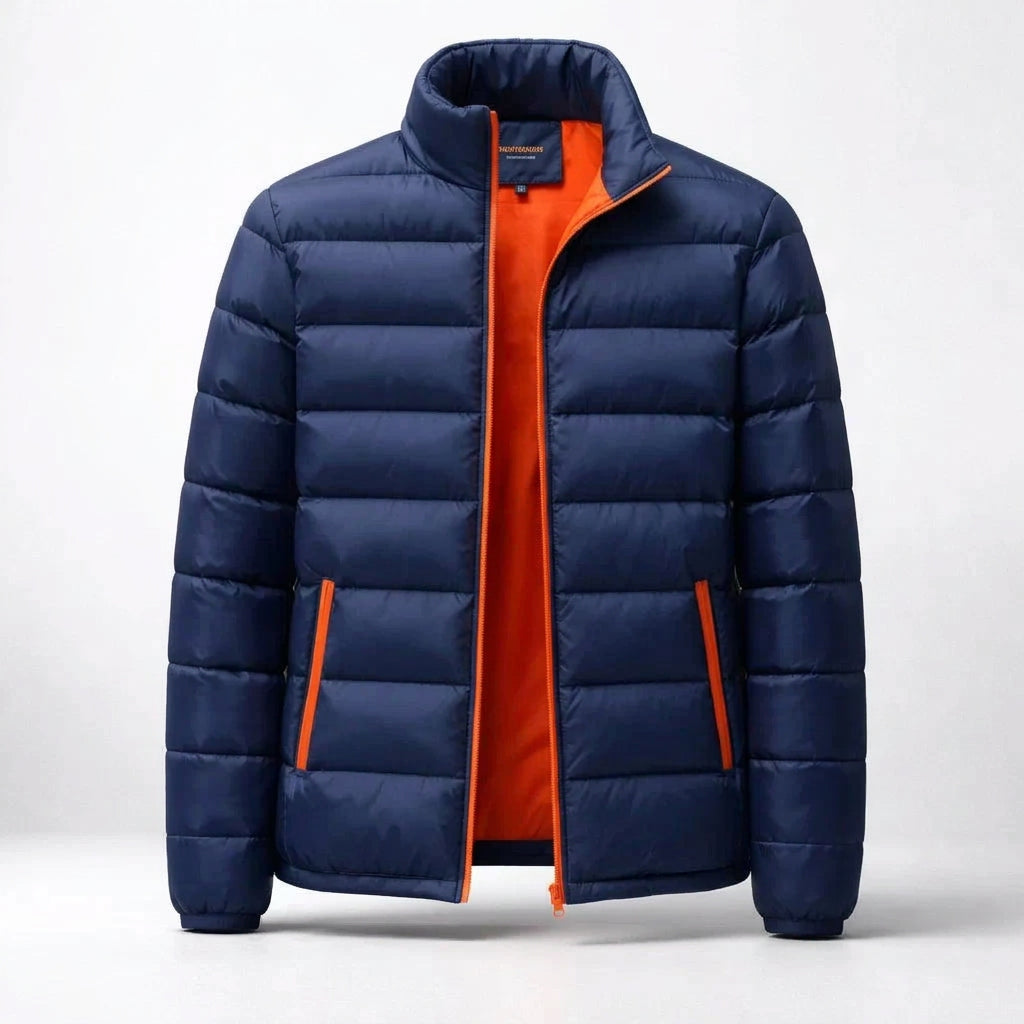 A navy blue puffer jacket with a bright orange interior lining and zipper trim, shown open against a light gray studio background.